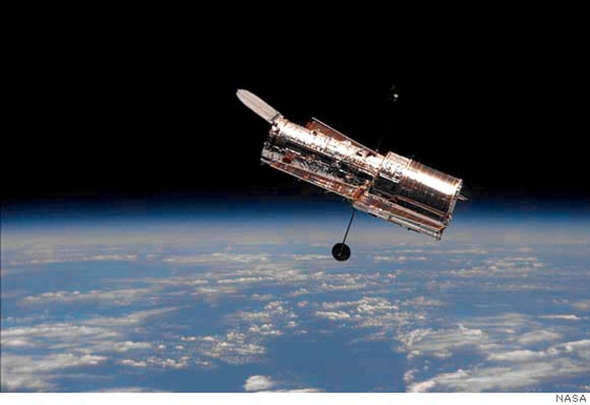 **FILE** The Hubble Space Telescope is shown following its release from the space shuttle Discovery in this Feb. 19, 1997 file photo. The Hubble Telescope will be allowed to degrade and eventually become useless, as NASA changes focus to President Bush's plans to send humans to the moon, Mars and beyond, officials said Friday, Jan. 16, 2004. (AP Photo/NASA, File)