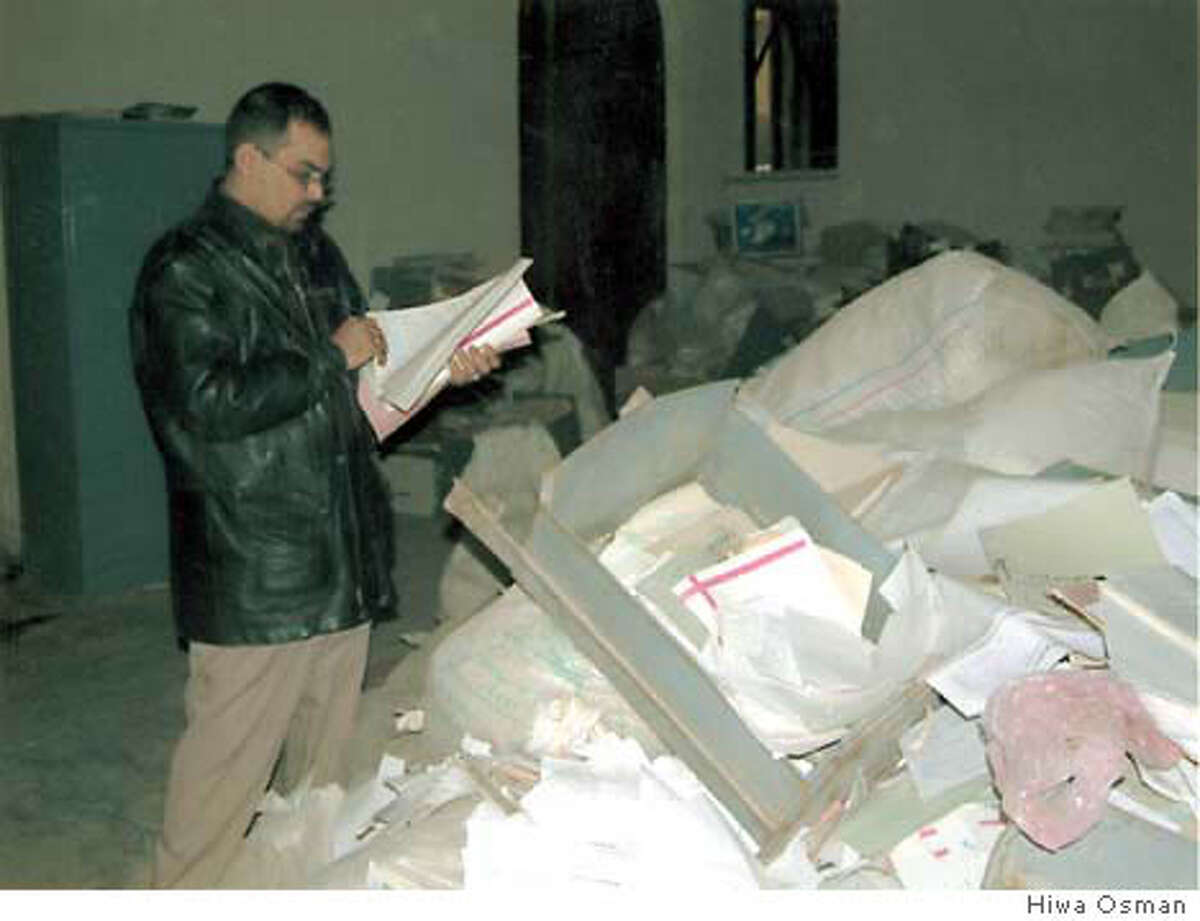 Inspectors search through piles of death warrants personaly signed by Saddam Hussein.