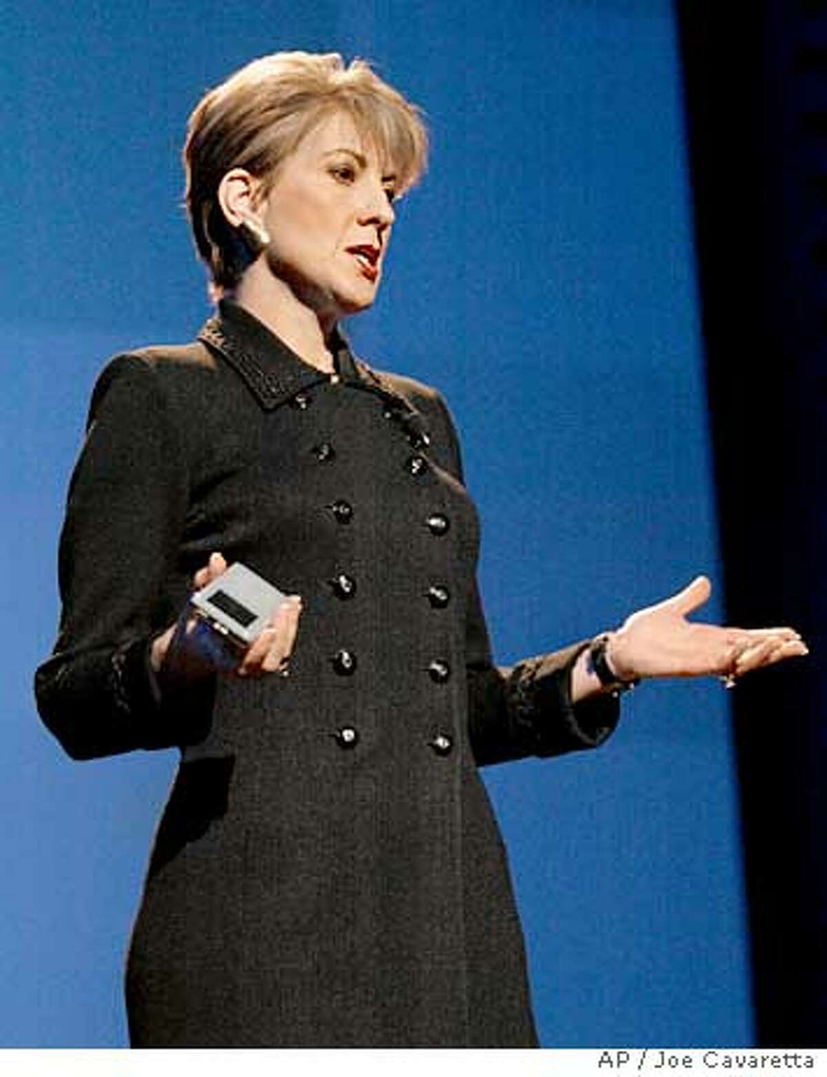 Carly Fiorina, Chairman and CEO of HP, holds an HP iPod during a keynote address of the Consumer Electronics Show at the Las Vegas Convention Center Hilton Hotel Thursday, Jan. 8, 2004. HP announced a partnership with Apple.(AP Photo/Joe Cavaretta)