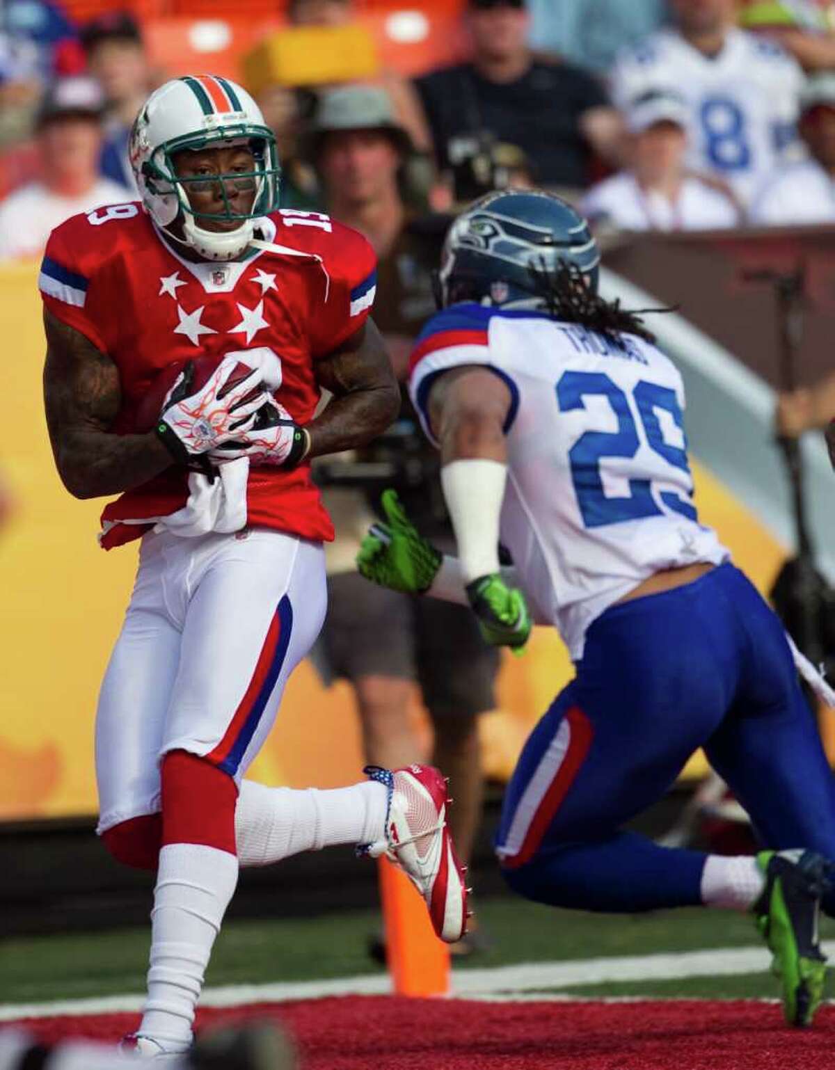 The AFC's Brandon Marshall beats Earl Thomas for one of his four touchdown receptions.