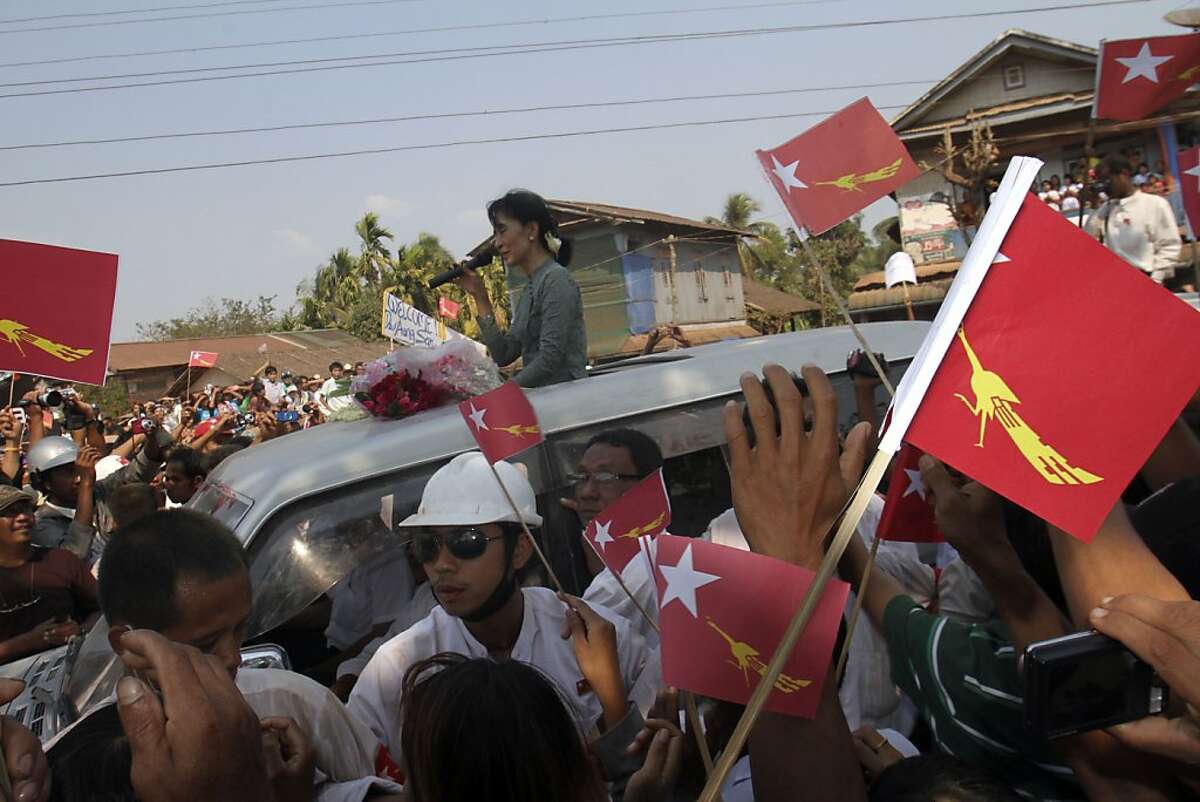 Myanmar pro-democracy leader Aung San Suu Kyi delivers her speech to supporters from her car as she arrives Sunday, Jan.2 9, 2012, in Dawei, about 615 km (380 miles) south of Yangon, Myanmar. Thousands of supporters in Myanmar's countryside cheered opposition leader Aung San Suu Kyi during her first campaign tour for parliament Sunday, highlighting how quickly and dramatically politics is changing in this long-repressed Southeast Asian nation. (AP Photo/Khin Maung Win)