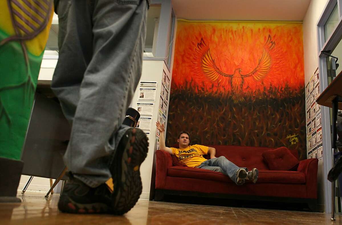 Student Adam Bruce talks with Hugo Ramirez as he relaxes under one of the murals created by Leonard Crow Dog, son of the Chief of the Lakota Sicangu Indians in South Dakota, Tuesday January 17, 2012, in Stephens Hall at UC Berkeley in Berkeley, Calif.