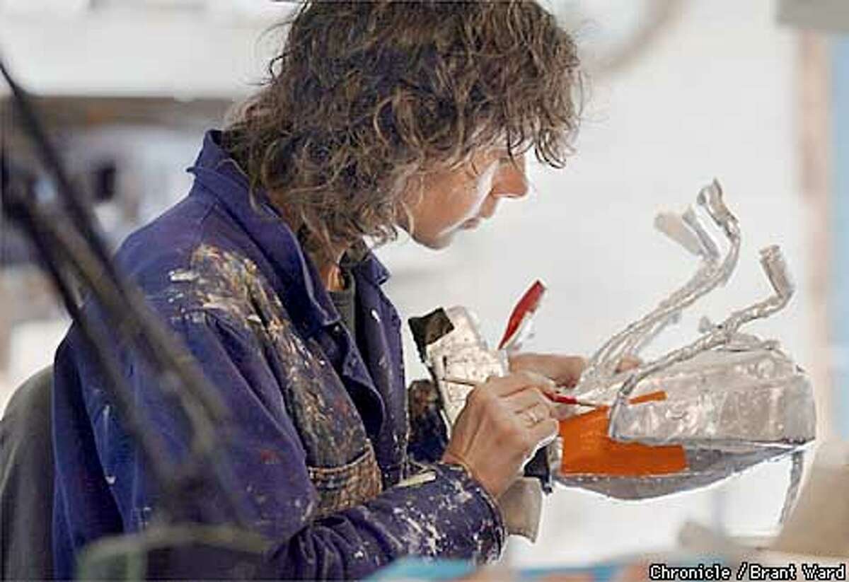 Brigitte Laurent (check spelling) handpaints all of the small folksy sculptures that her husband Patrick makes. She works in a large single-room building in the back of their Sebastapol home. By Brant Ward/Chronicle