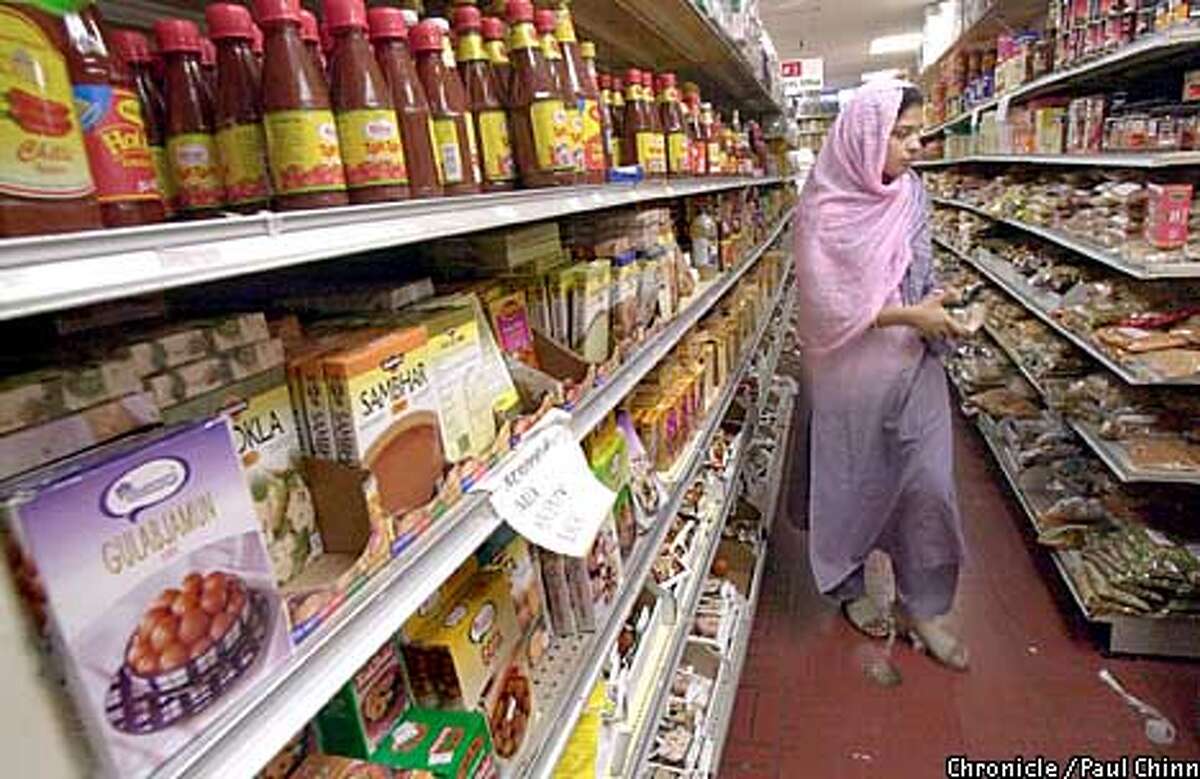 A shopper navigated a narrow aisle at Bharat Bazaar in Santa Clara which is the granddaddy of Indian markets in the South Bay. PAUL CHINN/S.F. CHRONICLE