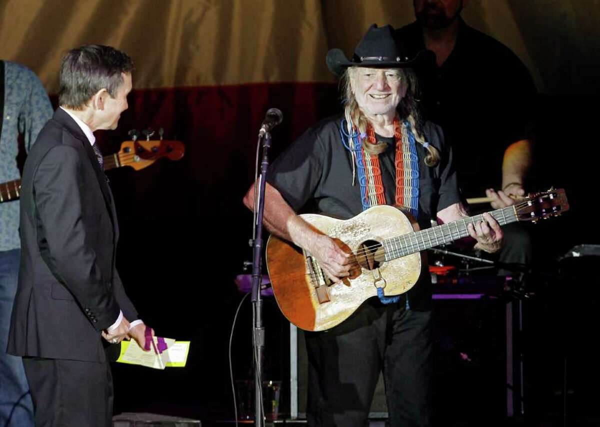 Country music icon Willie Nelson smiles before a fundraising concert for U.S. Rep Dennis Kucinich, left, in Lorain, Ohio, Sunday, Jan. 29, 2012. Redistricting has pitted Kucinich, a Cleveland Democrat, against the Toledo area congresswoman Marcy Kaptur, in the March primary. (AP Photo/Mark Duncan)