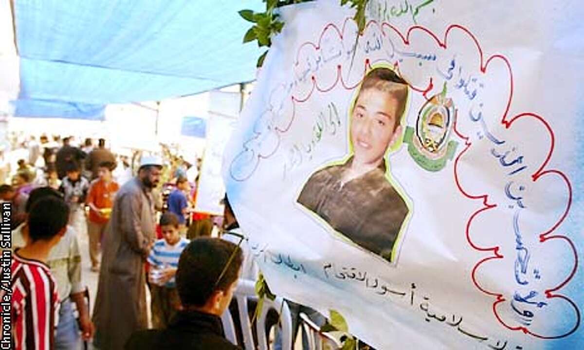 A photo of 15 year old Ahmad Omar is on display at a gathering on Friday April 19, 2002 in Gaza City. Omar was shot and killed by Israeli soldiers when he tried to enter the jewish settlement of Dugit in Gaza on Thursday. Photo By Justin Sullivan/For The Chronicle
