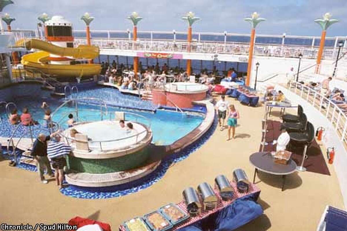Passengers indulge in tropical sunshine by the pool on Norwegian Cruise Line's $400 million Norwegian Star.