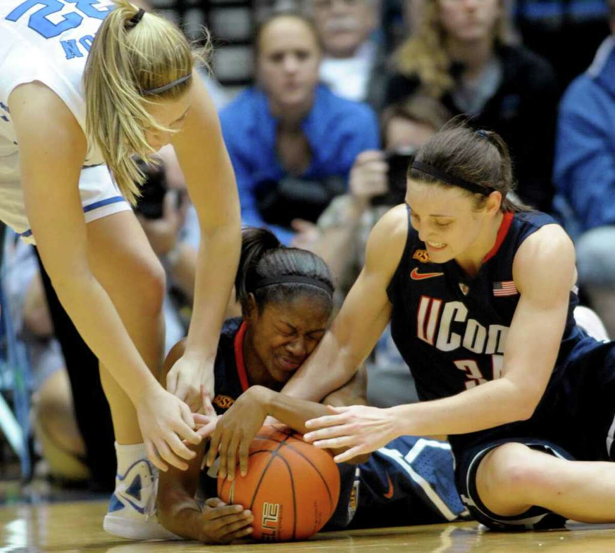 Connecticut's Tiffany Hayes (3) and Kelly Faris (34) battle for the ball from Duke's Tricia Liston (32) during the second half of an NCAA women's college basketball game, Monday, Jan. 30, 2012, in Durham, N.C. Connecticut won 61-45. (AP Photo/Sara D. Davis)