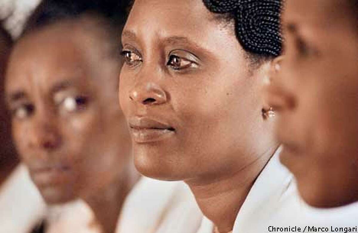 Rwanda, Genocide, Women Kigali, Rwanda, March 4, 2002. Athanasie Kankasi, 42, center, at the Clinic of Hope among other women victim of Genocide attending a support group. At the time of the Genocide Athanasie lived next an Army barrak. Within dats of her husband murder a school bus filled with soldierarrived at her home. Soldiers were to remain at her home on shift for the next three month. By her own account, Kankazi was raped by nearly 200 men. She was a sex slave in her own home. She testified in a 1999 UN conference on violence agaist women. Attending a weekly support group and counselling women herself helped her to move forward with her life. photo by Marco Longari/galbe.com (BY /FOR THE SAN FRANCISCO CHRONICLE; ONE-TIME USE ONLY)
