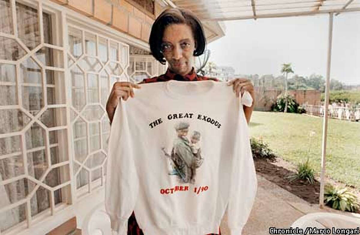 Kigali, Rwanda, 22nd February, 2002. Major Rose Kabuye, in her house in Kacyru (Kigali) shows a tee-shirt with her picture on it. The picture was taken in Byumba ( northern border with Uganda) during the invasion of October 1990, when the Rwandan Patriotic Army entered Rwanda to reach Kigali. Major Rose became after the first Mayor of Kigali after the Genocide of 1994. photo by Marco Longari / Galbe.Com horizontal color digital (BY /FOR THE SAN FRANCISCO CHRONICLE; ONE-TIME USE ONLY)