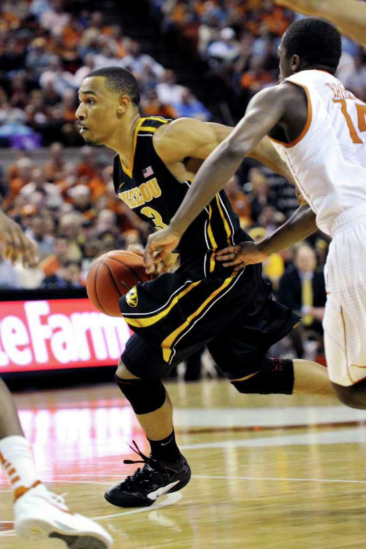 Missouri guard Matt Pressey (3) goes to the basket against Texas guard J'Covan Brown (14) during the first half of an NCAA college basketball game, Monday, Jan. 30, 2012, in Austin, Texas.
