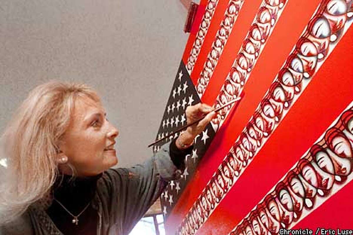 San Anselmo artist Vivianne Nantel puts some finishing touches to her version of the American flag called "United as One" an oil on canvas (36X60") which she plans to present to the American people as a gift with the help of Senator Diane Feinstein. Nantel's phone # 415.453.5359. BY ERIC LUSE/THE CHRONICLE