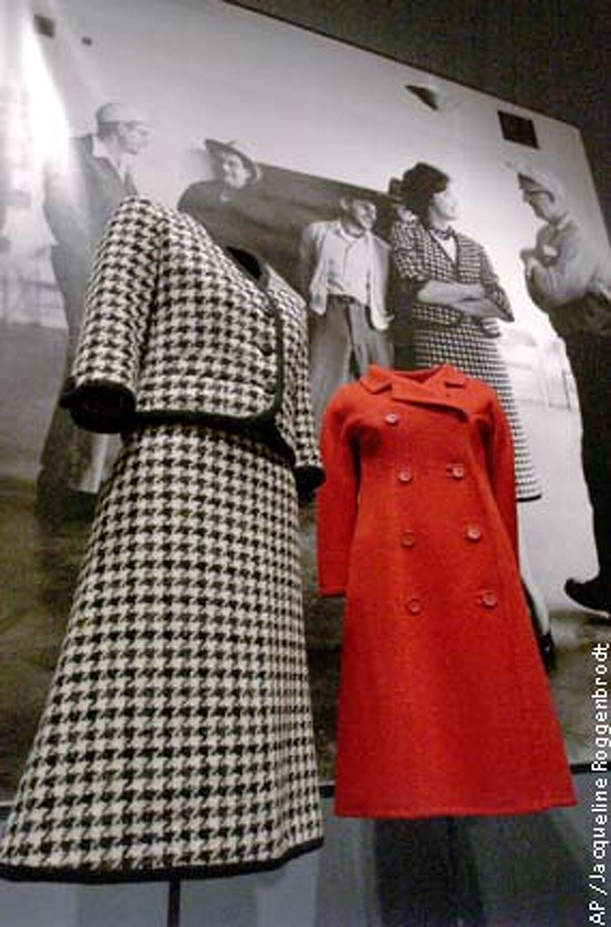 Two of Kennedy's fashion treasures: a black and white houndstooth suit with braided trim by Bob Bugnand, left, and a coat in scarlet double-faced wool by Hubert de Givenchy. Associated Press photo by Jacqueline Roggenbrodt