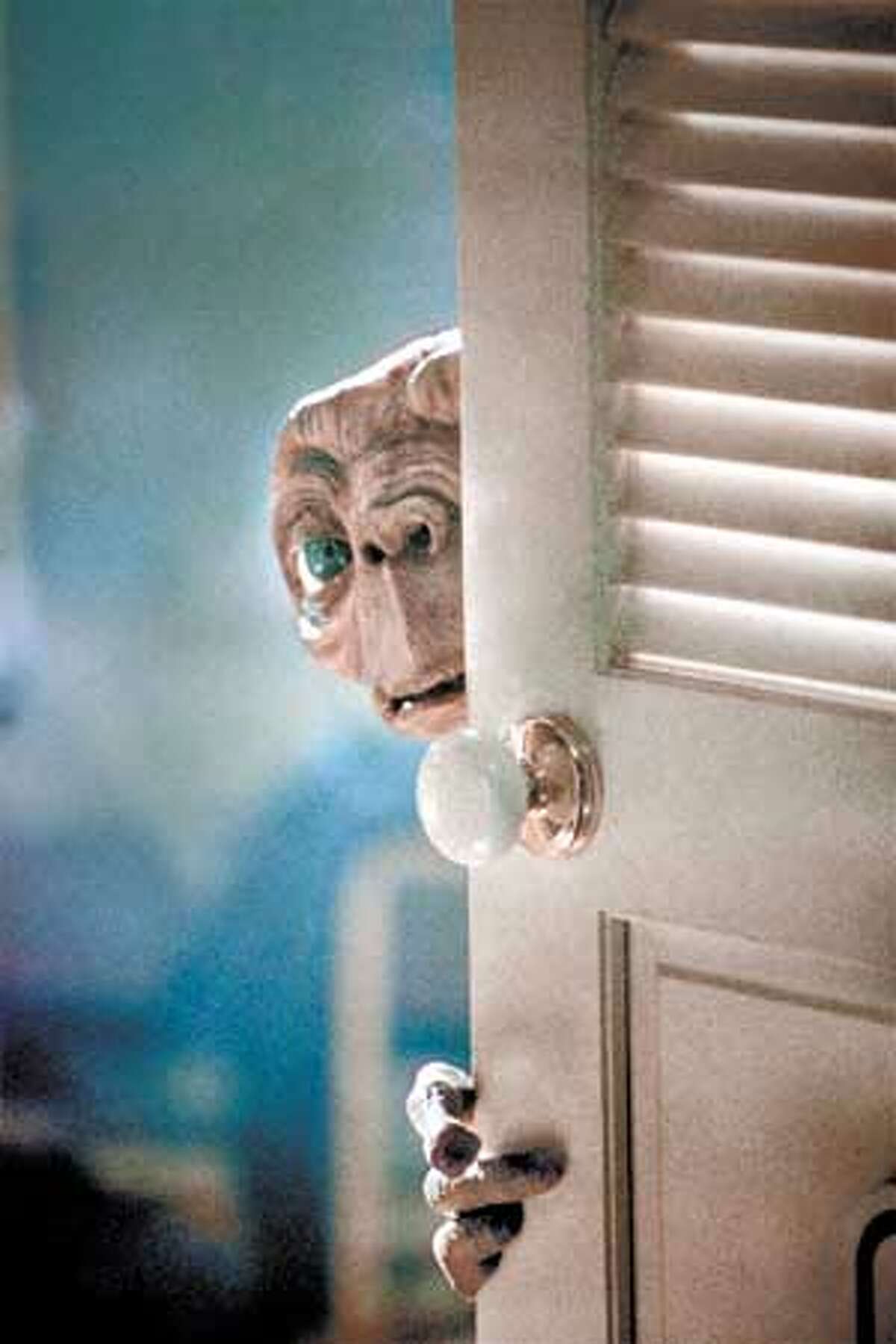 5550-K85-19AR E.T., separated from his own kind, warily explores Elliott�s house. Credit: Bruce McBroom All Rights Reserved Not For Sale or Duplication