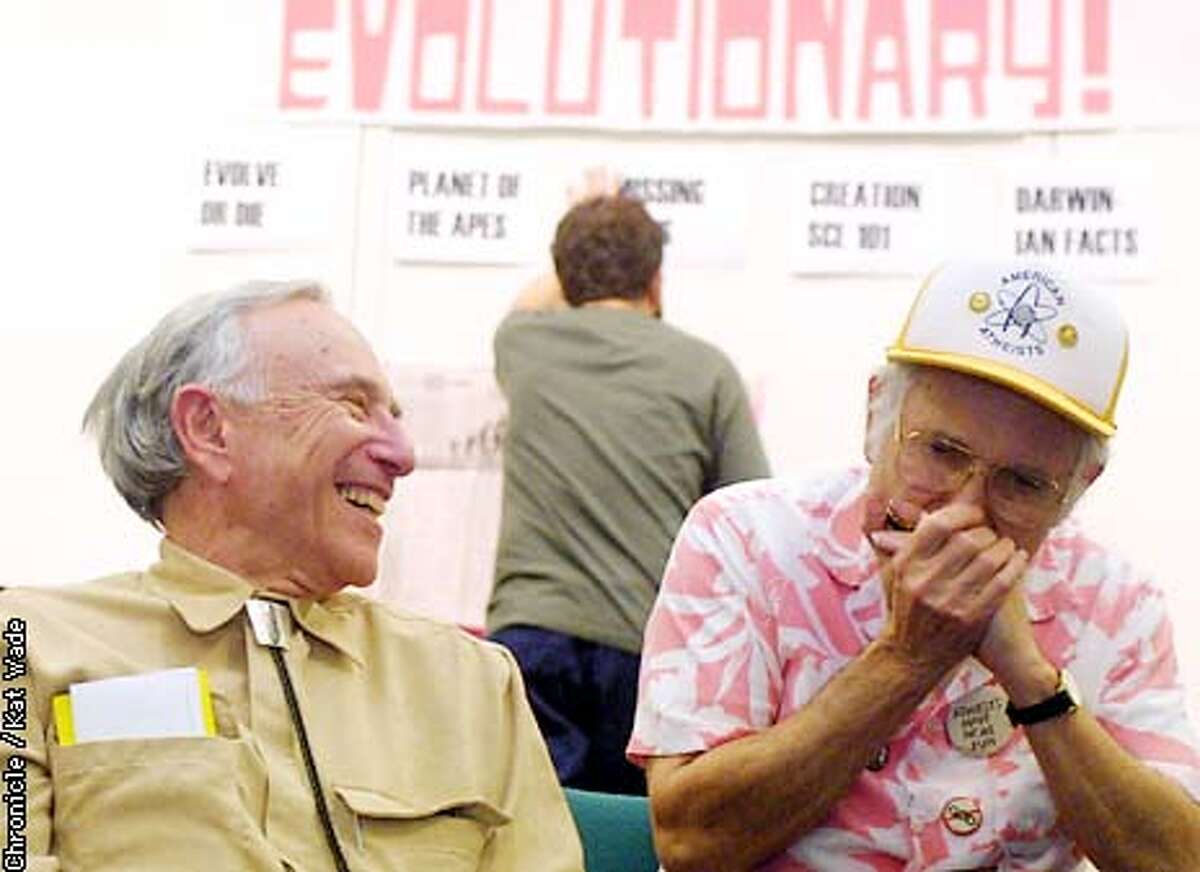 While co-organizer of the Darwin Party Dave Fitzgerald, (CENTER)of San Francisco sets up an Atheist version of Jeoparday, atheist club member (L to R) Harold Weingarten, of Alameda laughs as he listens to another Atheist, David Mandell, of Fremont play a tune on his harmonica during the atheist's celebration of Darwin's Birthday at the Rockridge library in Oakland.. SAN FRANCISCO CHRONICLE PHOTO BY KAT WADE