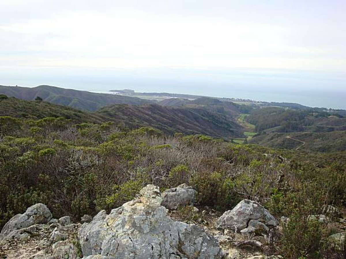 The view from Rocky Roost at Rancho Corral de Tierra takes in coastal foothills and valleys above Moss Beach and beyond to P illar Point Harbor and the Pacific Ocean.