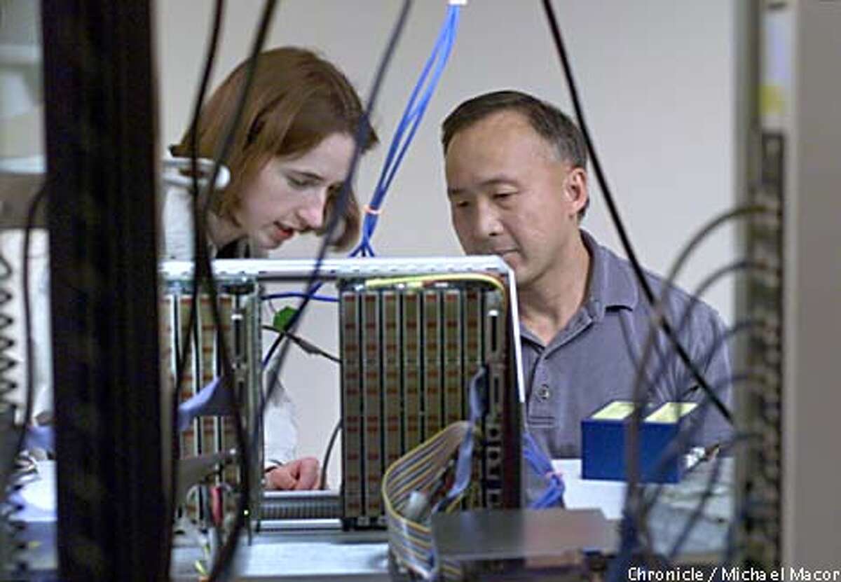 Sun product engineer Maire Mahony, left, and Ben Duong, an engineering technician, worked together on a component in San Jose. Chronicle photo by Michael Macor