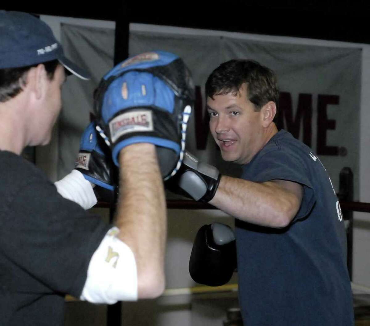 Episcopal minister Rev. Patrick Miller spars with co-owner Bobby Benton during his morning work outs at Main Boxing Gym Thursday 12/08/11. Photo by Tony Bullard.