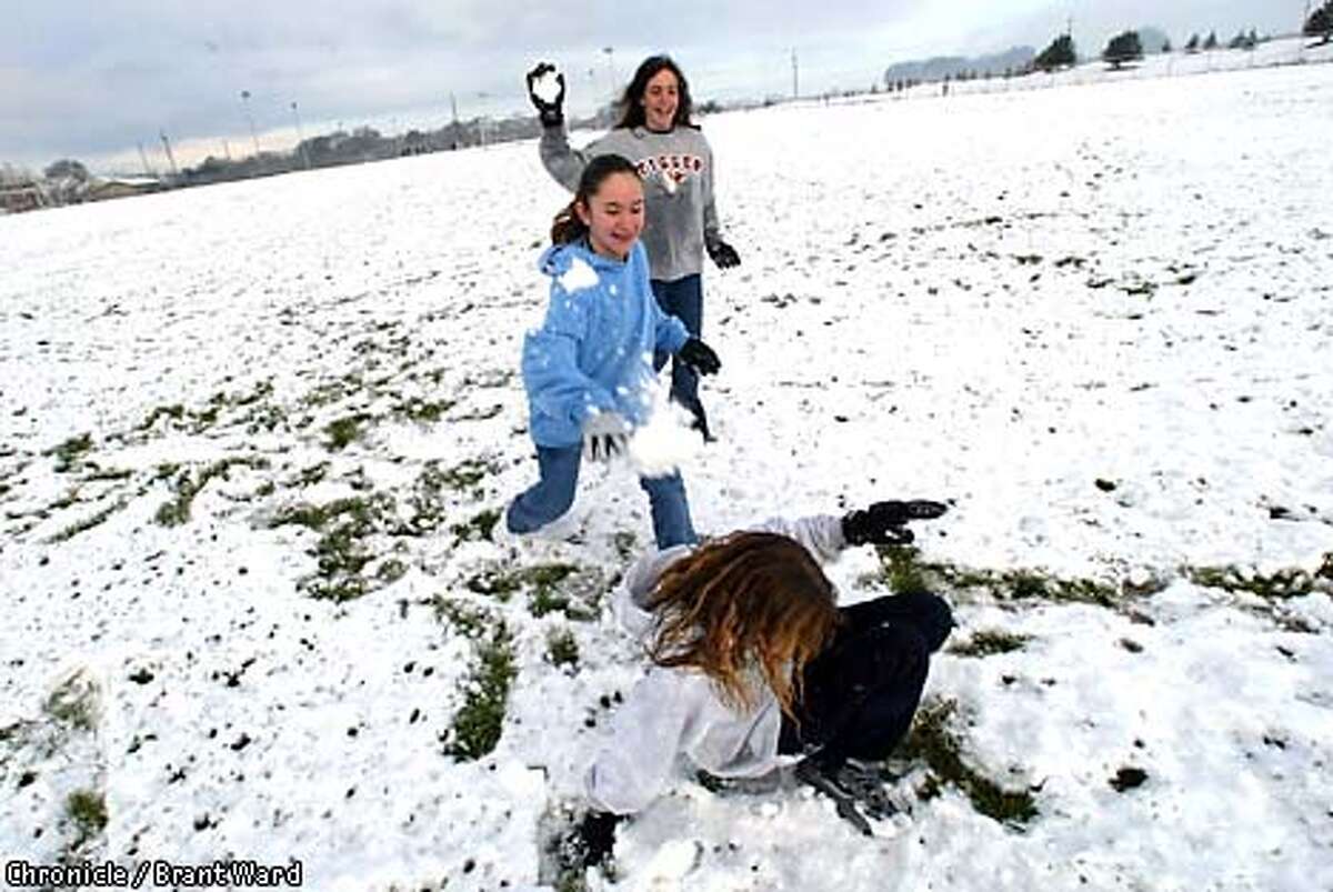 At Petaluma's Prince Park, a group of Junior High School students who had a "snow day" off from school got a little rough in the snow. Ashley Marshall, on ground, got attacked by Tiffany Ryman, in blue shirt (middle) and Alyson McConnell. By Brant Ward/Chronicle