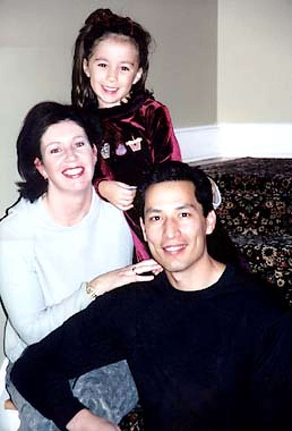 FILE -- Patrick Quigley, front, right, of Wellesley, Mass., is shown in this undated family photo with his wife, Patricia Quigley, and daughter Rachel, 5. Patrick Quigley was aboard United Airlines Flight 175 which crashed into the World Trade Center in New York on Tuesday, Sept., 11, 2001. (AP Photo/Family Handout, File)
