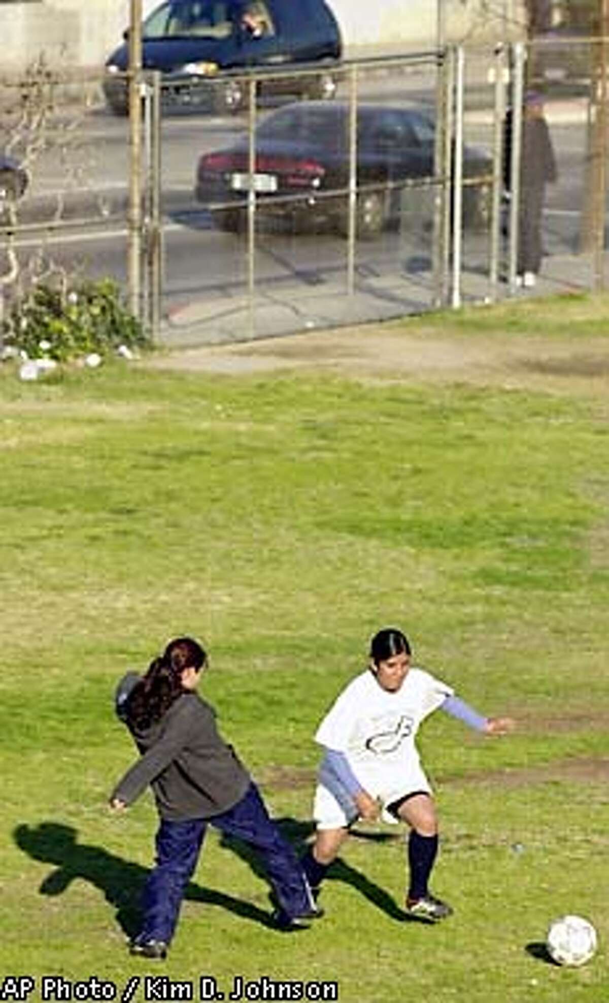 Students on the Huntington Park High School girls soccer team practice Thursday, Jan. 31, 2002 on one of the school's fields next to a busy street in Huntington Park, Calif. In California's smoggiest communities, the most athletic children are three times more likely than their couch-potato peers to get asthma, University of Southern California researchers have concluded. (AP Photo/Kim D. Johnson)