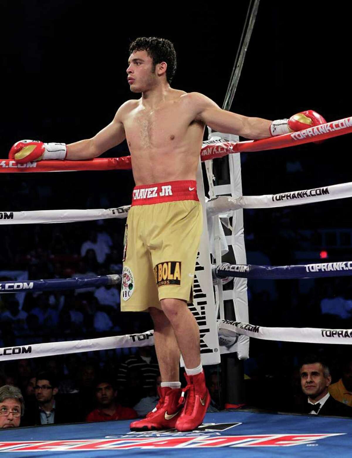 HOUSTON - NOVEMBER 19: Julio Chavez Jr. waits in a neutral corner as his apponent has some tape cut off his boxing glove> at Reliant Arena at Reliant Park on November 19, 2011 in Houston, Texas.