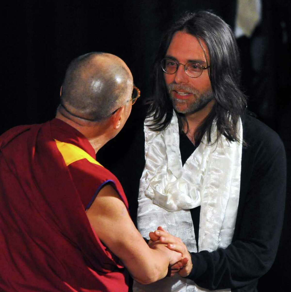 The Dalai Lama speaks onstage with Keith Raniere, right, co-founder of Executive Success Programs, Inc. (ESP), after giving him a Tibetan scarf following his talk at the Palace Theatre, in Albany, N.Y., Wed., May 6, 2009. (Philip Kamrass / Times Union)