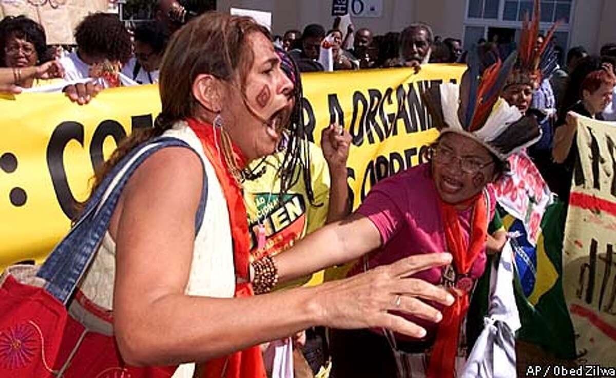 Members from the Indigenous People's Group in Brazil protest during the World Conference Against Racism in Durban, South Africa Tuesday Sept. 4, 2001. The protest was in reaction to the U.S. and Israeli walk out of the conference. The group was also protesting racism toward indigenous people as well as the right to self determination. (AP Photo/Obed Zilwa)