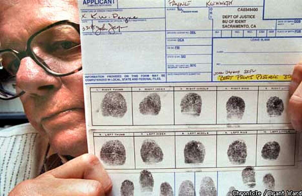 FINGERS/15APR98/CD/WARD--Ken Payne holds a copy of his fingerprints, which the state claims are not clear enough for him to teach anymore. By Brant Ward/Chronicle