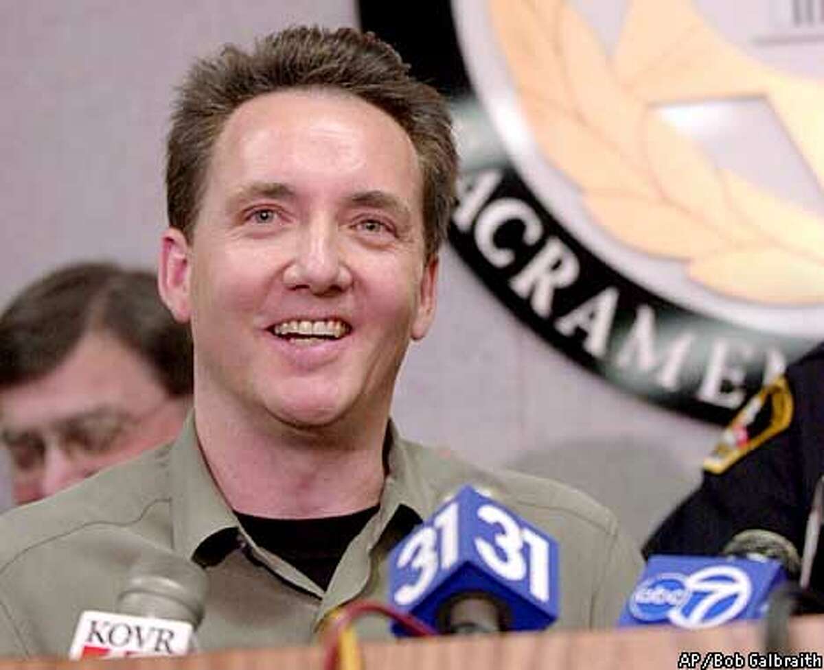 Dr. Jon Opsahl smiles during a news conference, Wednesday, Jan. 16, 2002, in Sacramento, Calif. Three former Symbionese Liberation Army members were arrested Wednesday in connection with a 27-year-old bank heist during which Opsahl's mother, Myrna, was killed. (AP Photo/Robert Galbraith)