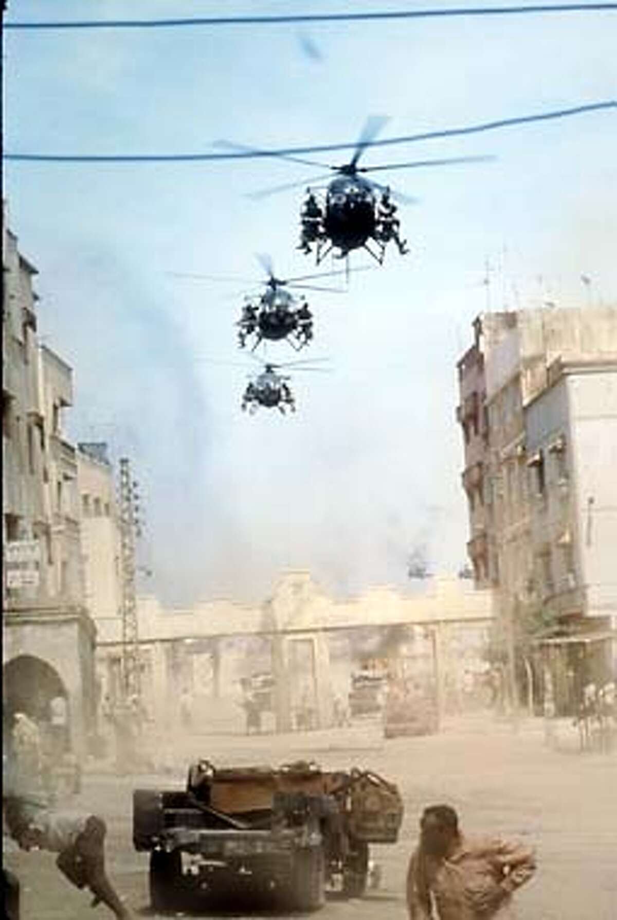 American soldiers arrive in Mogadishu in black hawk and Little bird helicopters in the Columbia Pictures film Blackhawk Down. HANDOUT.