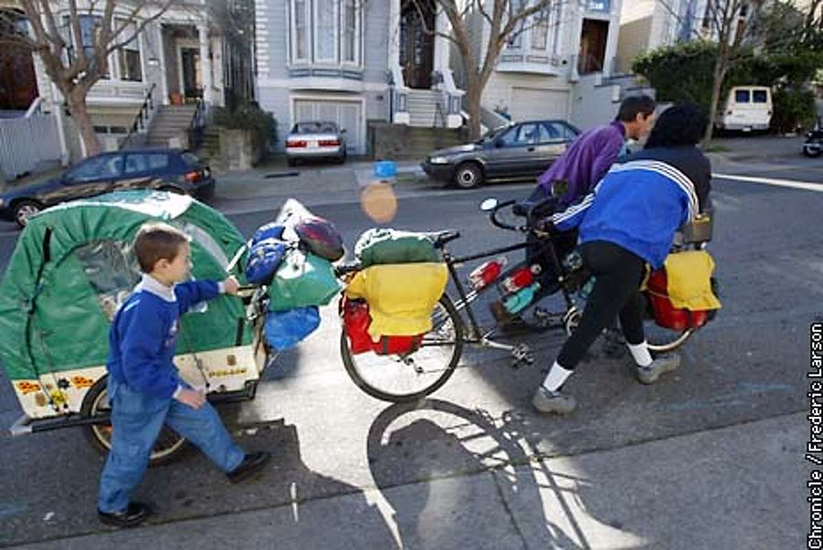 BICYCLE1-C-16JAN02-MT-FRL: Alain and Sylvie Soulat with thier son Aymeric Ulysse Soulat (7-year-old) is a French family that has been traveling around the world for 5+ years on a bicycle made for three and is now in SF. Chronicle photo by Frederic Larson