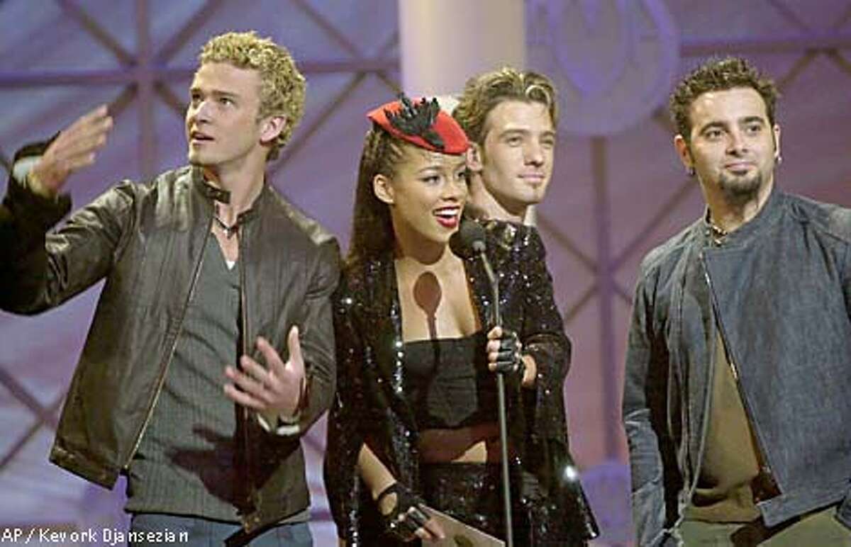Singer Alicia Keys was joined onstage by 'N Sync members Justin Timberlake (from left), JC Chasez and Chris Kirkpatrick at the American Music Awards. Associated Press photo by Kevork Djansezian