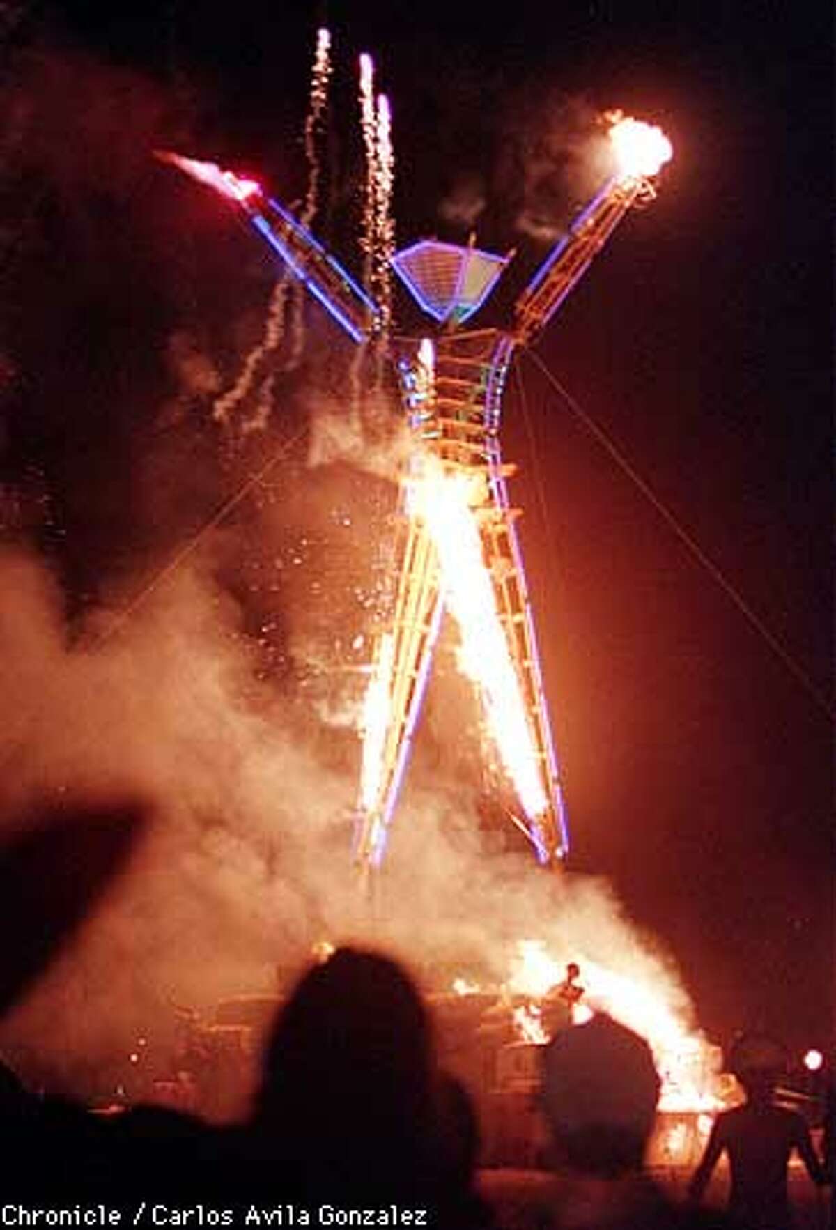 At the end of the five-day long Burning Man Festival, the four-story tall "Man" is burned and destroyed using explosives.(CHRONICLE PHOTO BY CARLOS AVILA GONZALEZ)