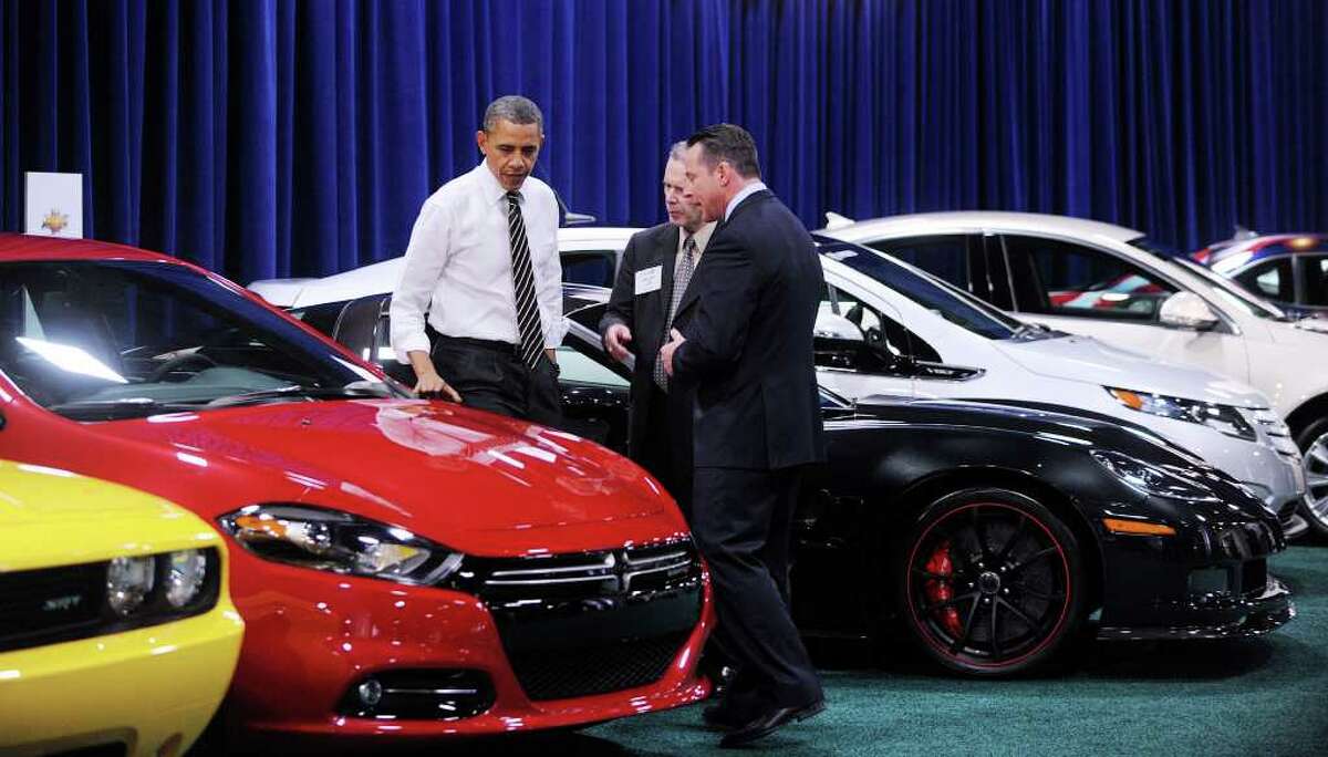 U.S. President Barack Obama looks at cars during a visit to the DC Auto Show at the Convention Center January 31, 2012 in Washington, DC.