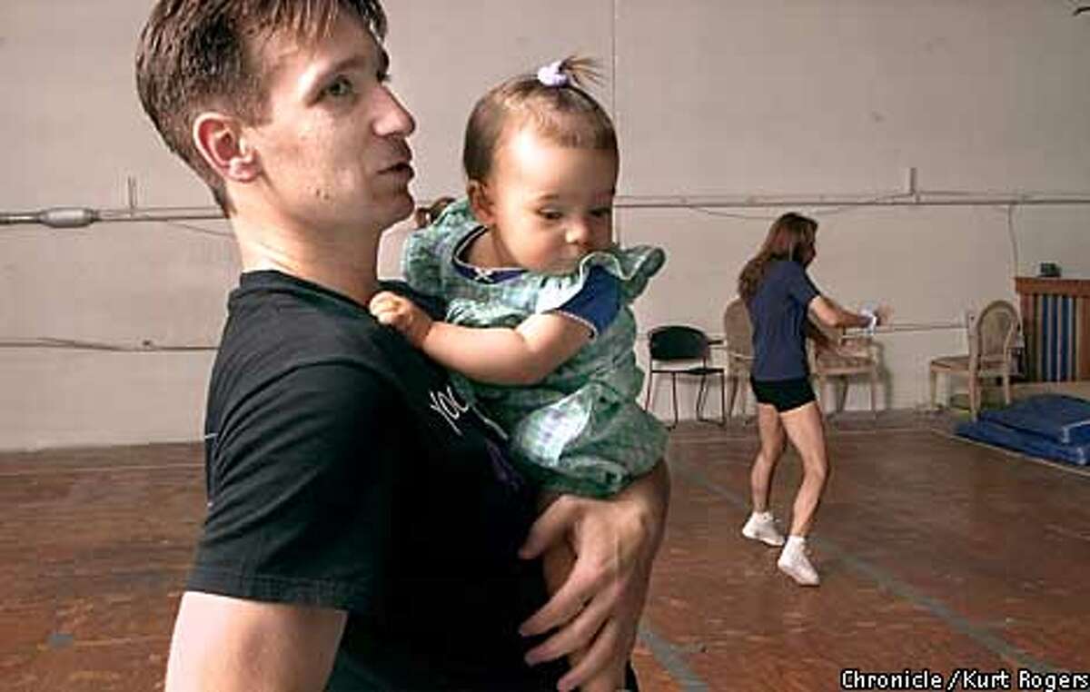 Dad holds nicole there doughter as mom works on her steps. Kaloyan Kaloyanov and Konstantza Popova-Kaloyanov husband and wife team are three-time world aerobices champions .They will be compiting in the world championships in San Francisco in July .Photo By Kurt Rogers