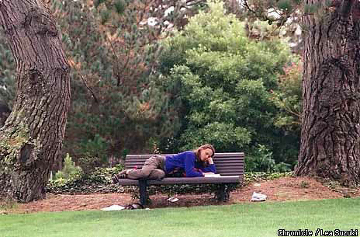 Jennifer Scopazzi, SFSU senior majoring in kinesiology, passes some time on campus enjoying a book under a grove of trees in the Quad on campus. Chronicle Photo by Lea Suzuki
