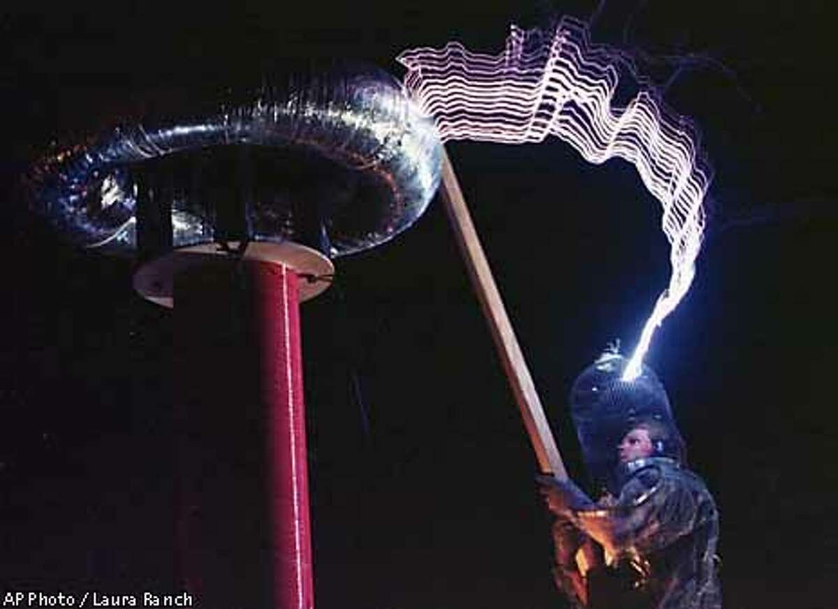 Mr. Mega Bolt creates lightning bolts as an expression of performance art during the festival in the Black Rock Desert near Gerlach, Nev. on Thursday, Sept. 2, 1999. The gathering, intented to be a celebration of radical free expression and self reliance, will host 20,000 people before its culmination on Saturday. (AP Photo/Laura Rauch)