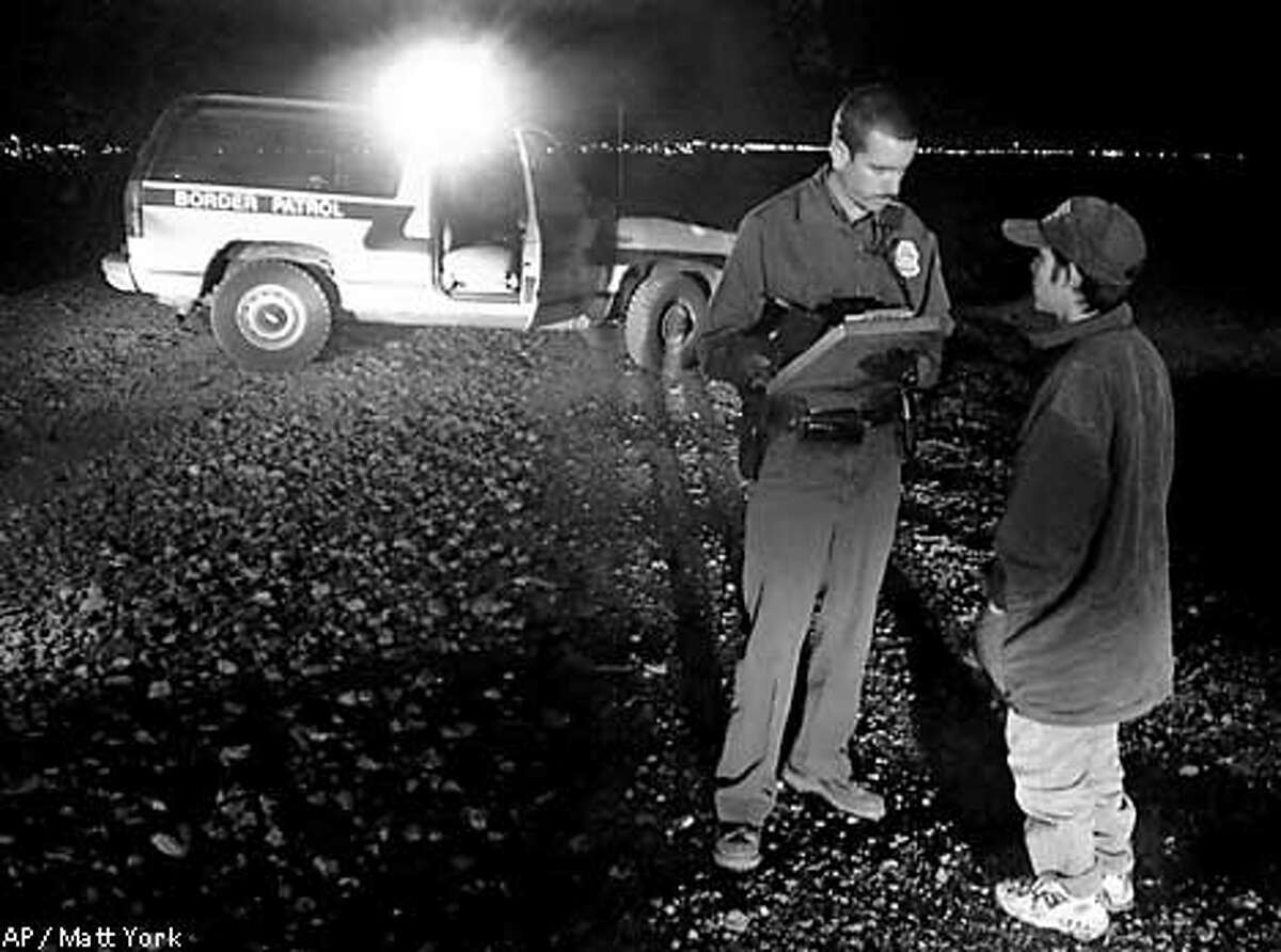 FILE-- U.S. Border Patrol agent Brent Barber takes information from a Mexican citizen, early morning hours of April 10, 2000, in Douglas, Ariz. Hundreds of Mexicans try to illegally cross into the United States via Aqua Prieta, Mexico every day. At least 66 illegal immigrants have died this year making their way through Arizona, the most the Border Patrol has ever recorded in the state. Last year, 40 people died crossing Arizona's border. (AP Photo/Matt York)