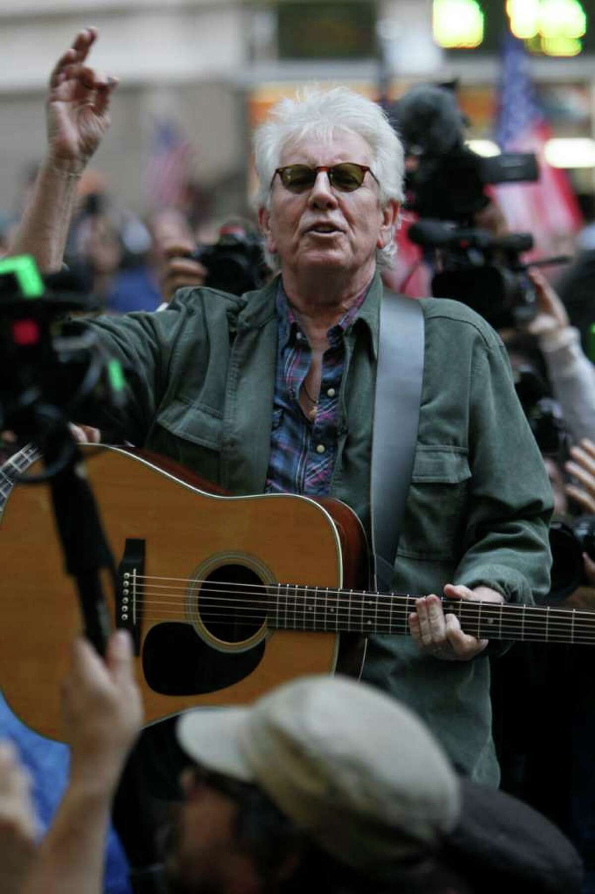 Graham Nash performs at the Occupy Wall Street encampment at Zuccotti Park, Tuesday, Nov. 8, 2011 in New York. (AP Photo/Mary Altaffer)