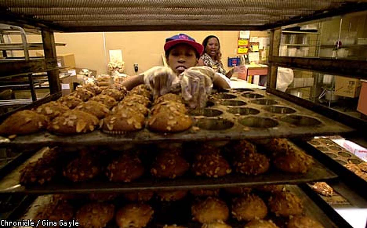 Sonia Jackson, left, prepared dozens of muffins for packaging as her job coach, Diane Dean, observed and gave her guidance. Chronicle photo by Gina Gayle