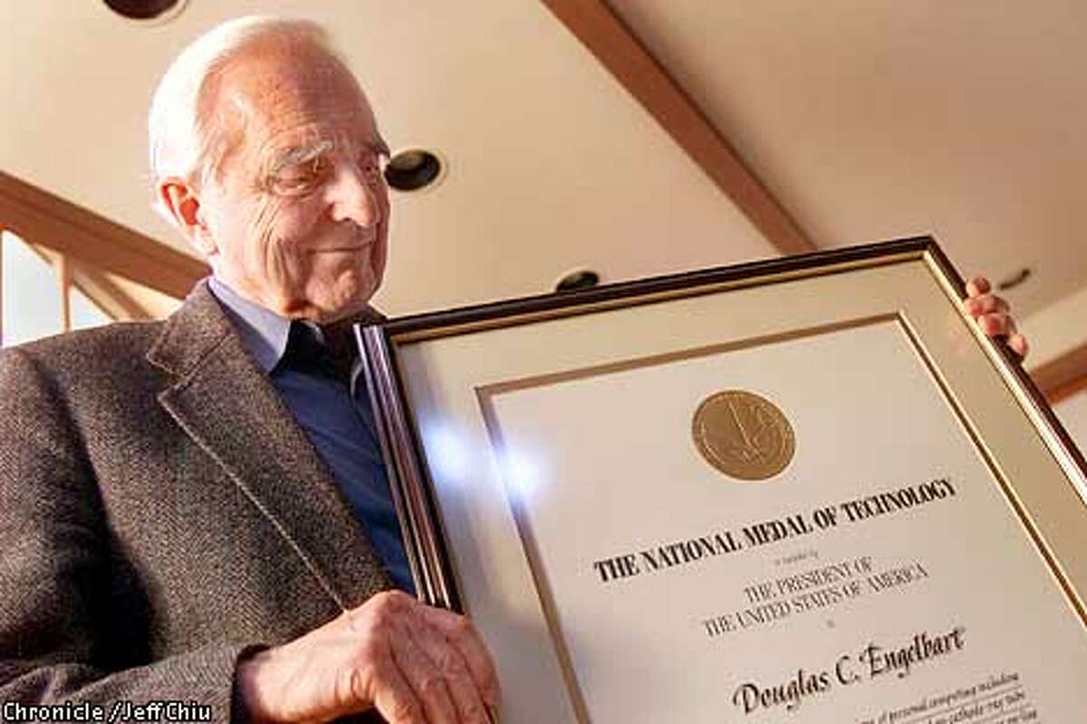 Douglas Engelbart displays his award of the National Medal of Technology at his Atherton home on Wednesday afternoon. Among his claims to fame is his invention of the computer mouse while at Stanford Research Institute in Menlo Park. Photo by Jeff Chiu / the Chronicle.