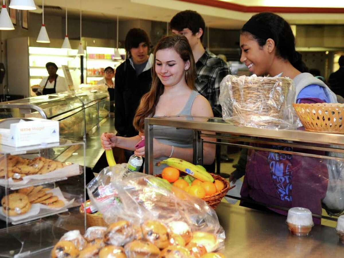 Jenny Ribeiro, 15, buys a banana at the cafeteria at Greenwich High School Wednesday, Feb. 1, 2012. The PTA Council's wellness committee is lobbying the district to provide healthier food to students.