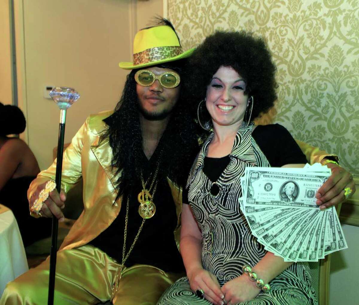Dramone Snell, from the left, and Denise Comer put on the '70s bling at the Motown Party fundraiser for the Queen of Soul pageant at The Bright Shawl, Saturday, January 28, 2012.
