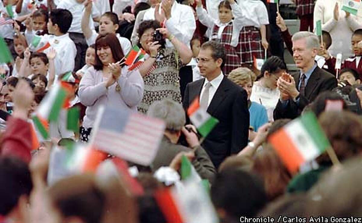 Governor Gray Davis, right, and Mexican President, Ernesto Zedillo are welcomed by cheers and waving Mexican and American flags at Breed Street Elementary School in East Los Angeles, Ca., on Thursday, May 20, 1999, the last day of Zedillo's three-day visit to California to work out business deals between California and Mexico. (CARLOS AVILA GONZALEZ/SAN FRANCISCO CHRONICLE)