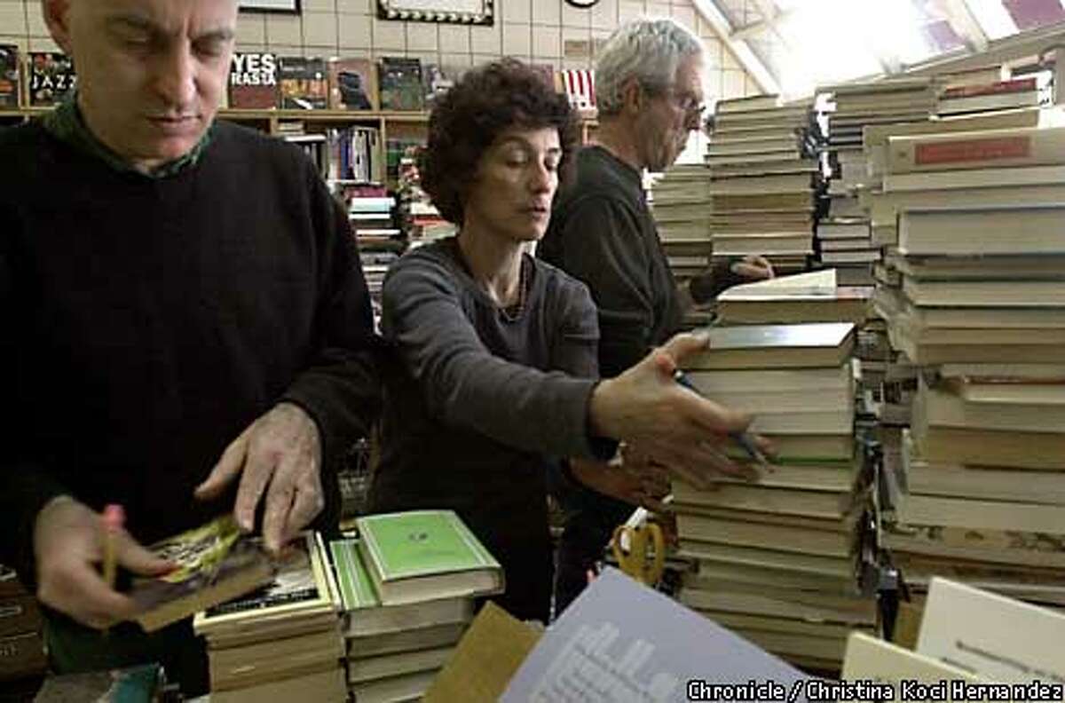 BOOKS20h-C-19APR01-MN-CH CHRISTINA KOCI HERNANDEZ/CHRONICLE At Moe's Books on Telegraph Ave. in Berkeley, employees (L to R)Stanley Sobolewski, new book manager Laura Tibbals and Dan Liebowitz organize used books they recently purchased. Independent bookstores lose lawsuit against chain bookstores, including Barnes and Nobles and Borders Books and Music for unfair pricing. Photographs taken at Moes bookstore on Telegraph in Berkeley, an independent bookstore.