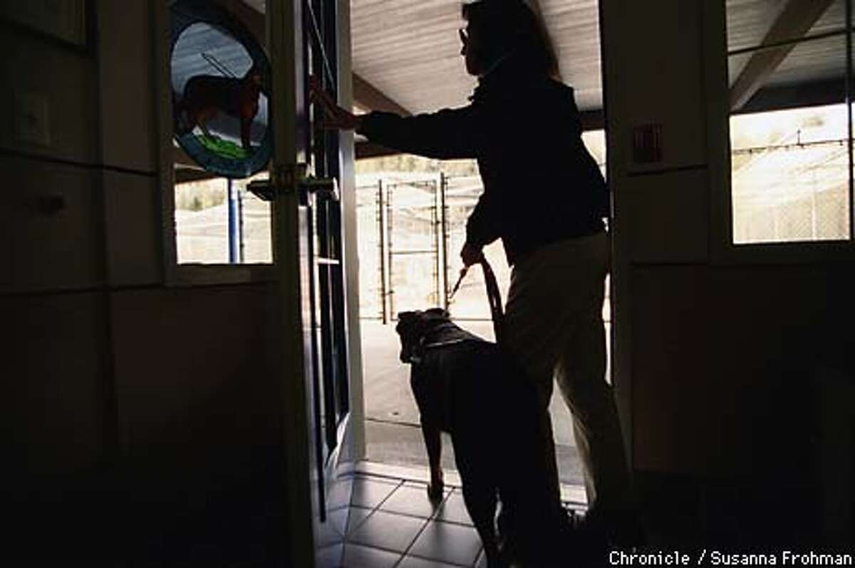 Guide Dogs for the Blind tour guide Aerial Gilbert leaves the school's veterinary clinic with her Guide Dog, Deanne. (CHRONICLE PHOTO BY SUSANNA FROHMAN)