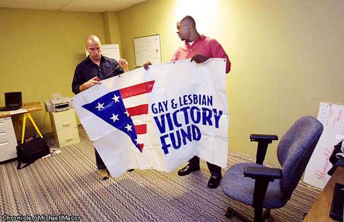 The "Gay and Lesbian Victory Fund" opened it's doors on Monday. (Director) Tony Esoldo, left and Byron Mills, (Developement Manager Western Office) hang their banner inside the Mission St. office. by Michael Macor/The Chronicle