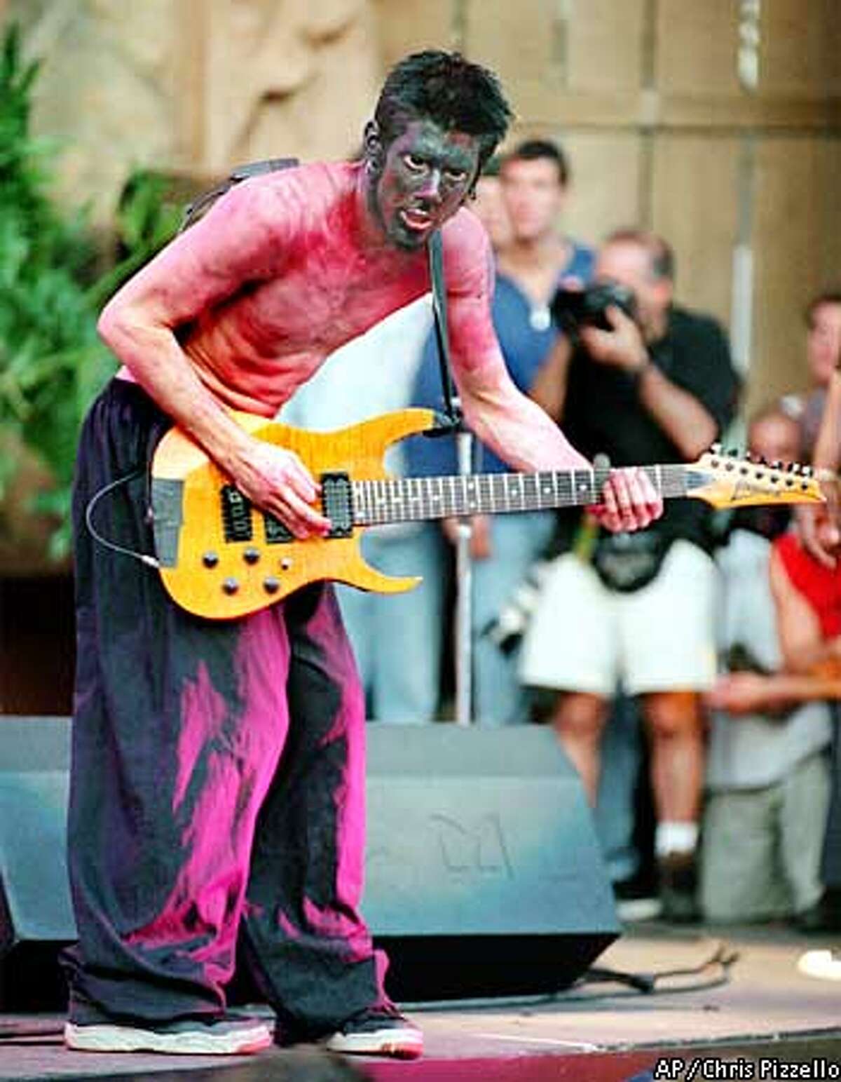 Limp Bizkit guitarist, Wes Borland, performs during his band's set at the annual KROQ Weenie Roast summer concert Sunday, June 20, 1999 at Irvine Meadows Amphitheatre in Irvine, Calif. Limp Bizkit performed along with other popular alternative-rock acts including Sugar Ray, Blink-182, Metallica and the Red Hot Chili Peppers. (AP Photo/Chris Pizzello)
