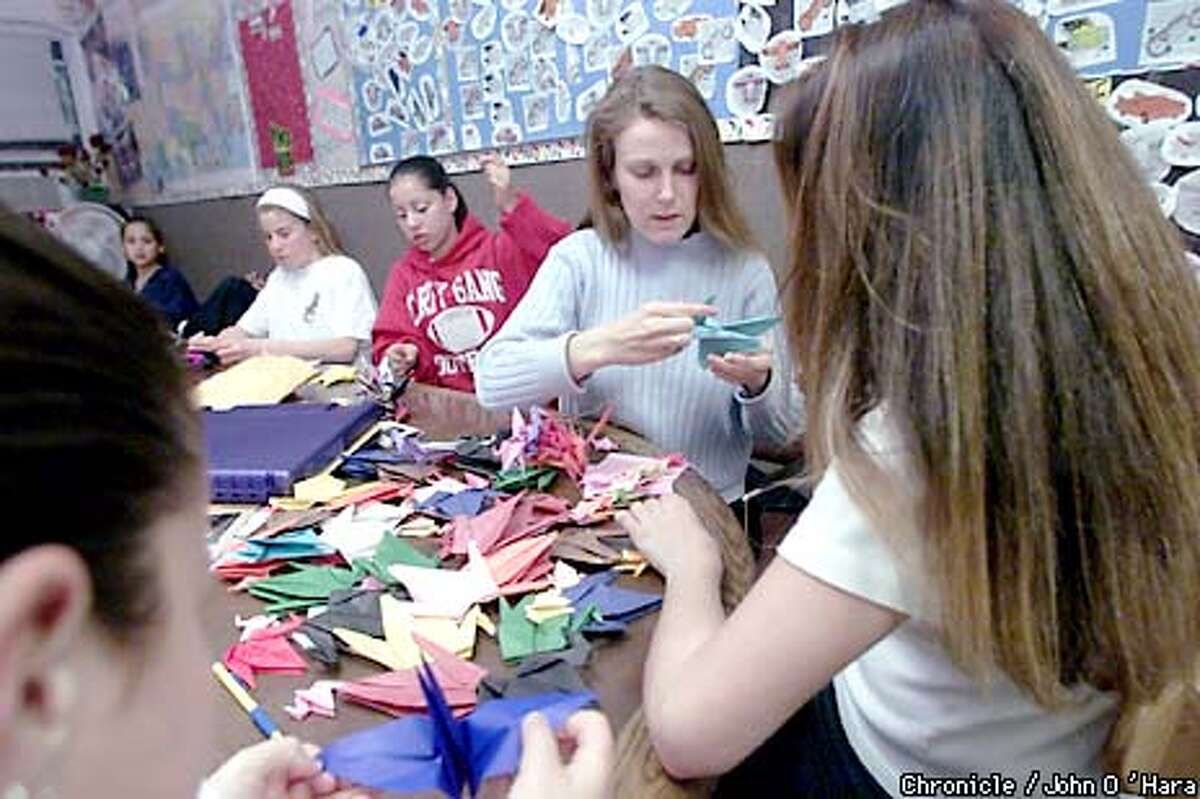 Napa, CA. NAPA Boys and GOrls Club, 2310 FIrst st. "Origami" A thousand Cranes. made by these young people and will be strung together. Kelly Dunn and Kim Hughes, working on a string of cranes Photo/John O'Hara